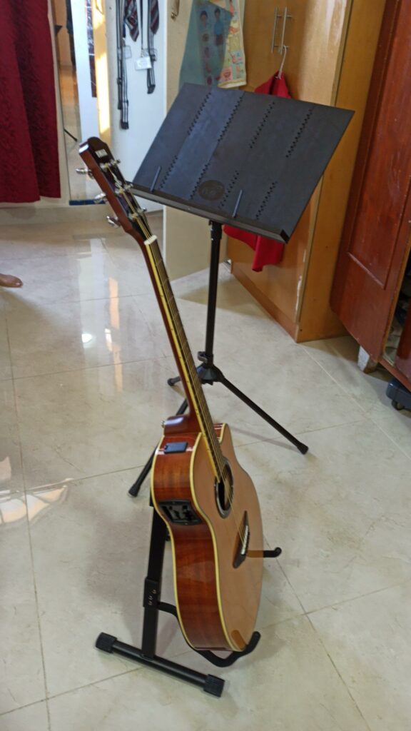 The Amazon Adjustable Guitar Folding A-Frame Stand is designed to hold both acoustic and electric guitars.